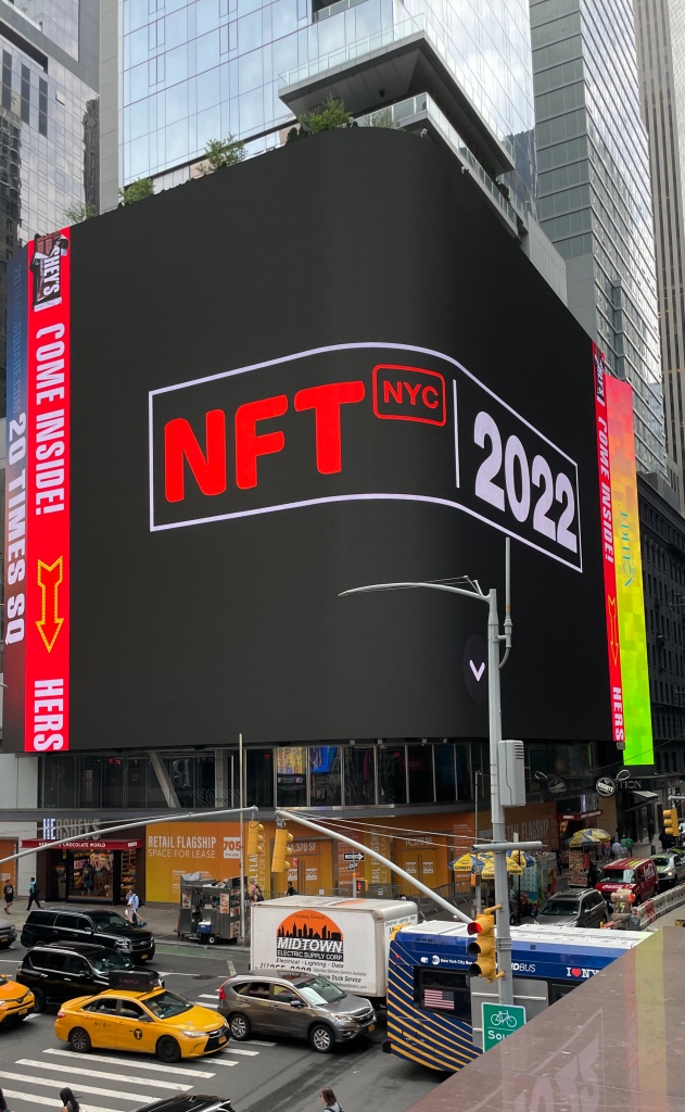 Image of the Times Square poster announcing NFT.NYC 2022.